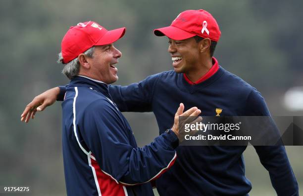 Fred Couples the Captain of the USA Team races to congratulate Tiger Woods after he had holed the winning putt at the 13th hole where he beat his...