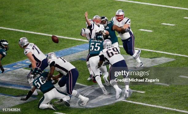 Tom Brady of the New England Patriots fumbles the ball while being sacked by Brandon Graham of the Philadelphia Eagles in Super Bowl LII at U.S. Bank...