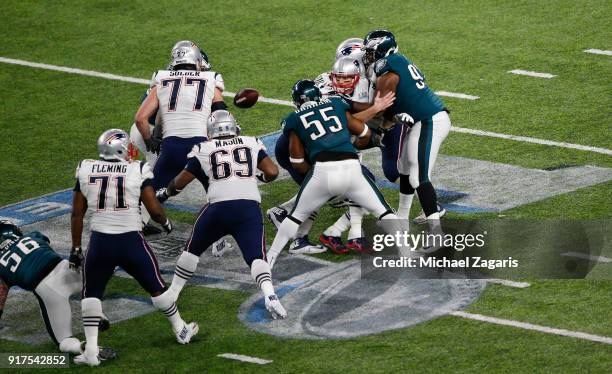 Tom Brady of the New England Patriots fumbles the ball while being sacked by Brandon Graham of the Philadelphia Eagles in Super Bowl LII at U.S. Bank...