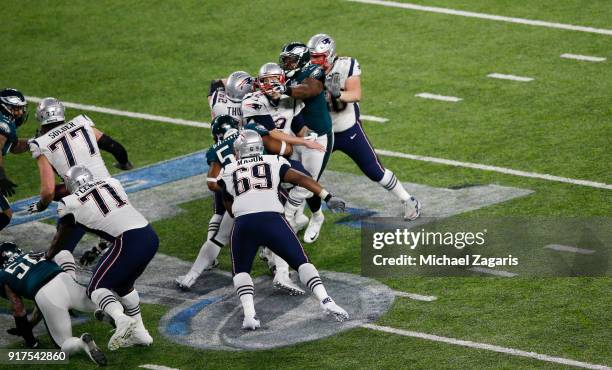 Tom Brady of the New England Patriots fumbles the ball while being sacked by Brandon Graham of the Philadelphia Eagles in Super Bowl LII at U.S. Bank...