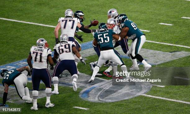 Tom Brady of the New England Patriots fumbles the ball while being sacked by Brandon Graham of the Philadelphia Eagles in Super Bowl LII at U.S. Bank...