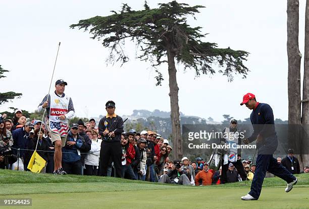 Tiger Woods of the USA Team birdies the 9th hole in his match against Y.E.Yang of South Korea and the International Team during the Day Four Singles...
