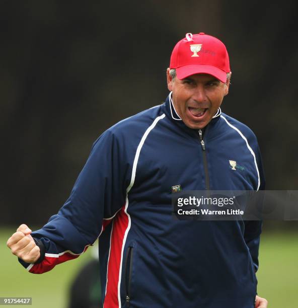 Fred Couples, Captain of the USA Team celebrates after Tiger Woods wins his Singles Match against Y. E. Yang of the International Team and wins The...