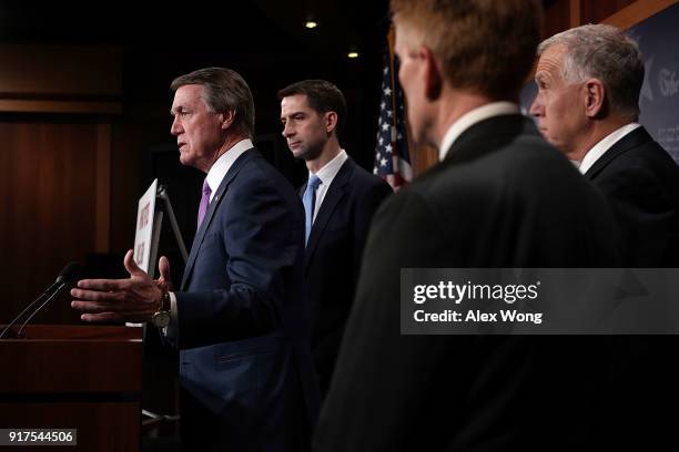 Sen. David Perdue speaks as Sens. Tom Cotton , James Lankford and Thom Tillis listen during a news conference on immigration February 12, 2018 at the...