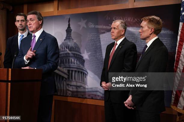 Sen. David Perdue speaks as Sens. Tom Cotton , Thom Tillis and James Lankford listen during a news conference on immigration February 12, 2018 at the...