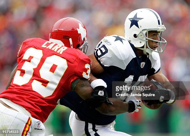 Miles Austin of the Dallas Cowboys carries the ball as Brandon Carr of the Kansas City Chiefs defends during the game on October 11, 2009 at...