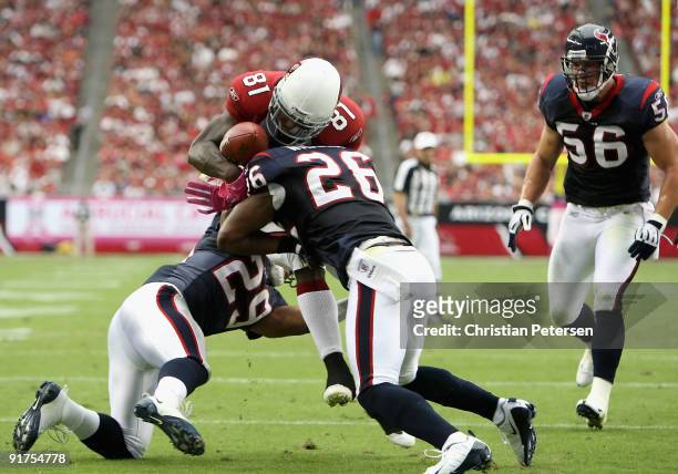 Wide receiver Anquan Boldin of the Arizona Cardinals has the ball knocked free after a reception by Eugene Wilson of the Houston Texans during the...