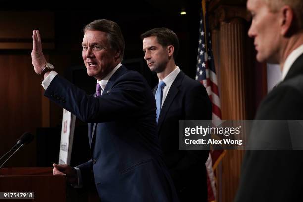 Sen. David Perdue speaks as Sens. Tom Cotton and James Lankford listen during a news conference on immigration February 12, 2018 at the Capitol in...
