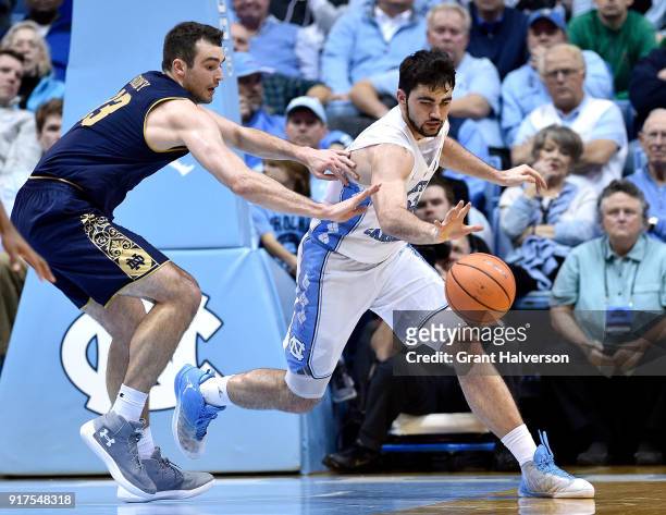 John Mooney of the Notre Dame Fighting Irish and Luke Maye of the North Carolina Tar Heels chase down a loose ball during their game at the Dean...