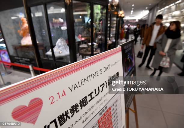 This photo taken on January 29, 2018 shows customers looking at a temporary booth of Japanese chocolate shop Kloka set up ahead of Valentine's Day at...