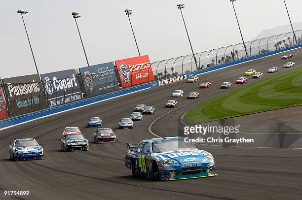 Jimmie Johnson, driver of the Lowe's Chevrolet, leads a line of cars during the NASCAR Sprint Cup Series Pepsi 500 at Auto Club Speedway on October...