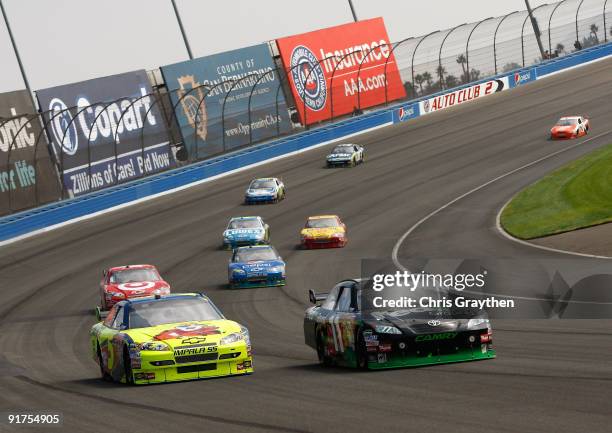 Mark Martin, driver of the Kellogg's Chevrolet, battles Denny Hamlin, driver of the FedEx Toyota, during the NASCAR Sprint Cup Series Pepsi 500 at...