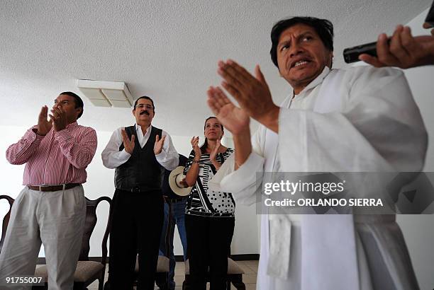 - Picture taken on October 4, 2009 of Father Andres Tamayo offering mass inside the Brazilian embassy next to toppled Honduran President Manuel...