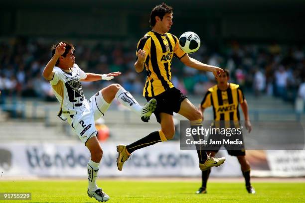 Efrain Velarde of Pumas vies for the ball with Diego Alonso of Penarol during their friendly match as part of the 80 years of the University Autonomy...