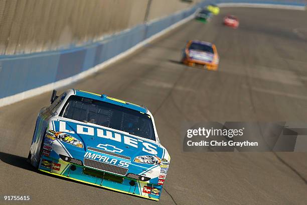 Jimmie Johnson, driver of the Lowe's Chevrolet, races during the NASCAR Sprint Cup Series Pepsi 500 at Auto Club Speedway on October 11, 2009 in...