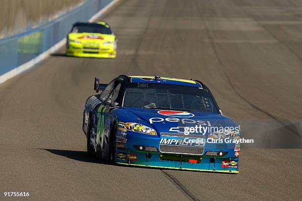 Jeff Gordon, driver of the Pepsi Chevrolet, leads teammate Mark Martin, driver of the Kellogg's Chevrolet, during the NASCAR Sprint Cup Series Pepsi...