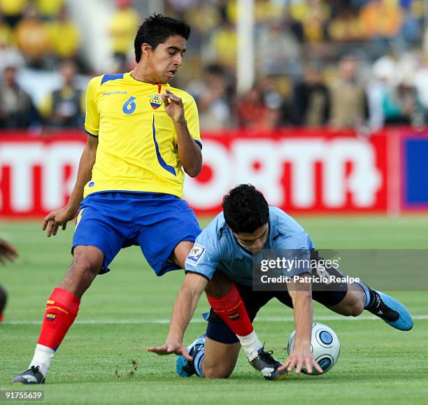Ecuador's Christian Noboa figths for the ball with Uruguay's Luis Suarez during their FIFA 2010 World Cup Qualifying match at Atahualpa Olympic...
