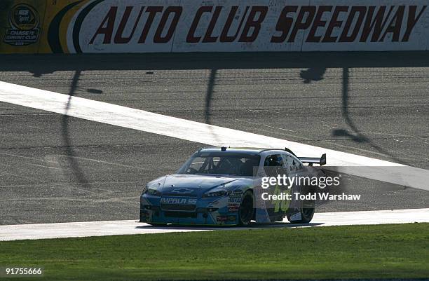 Jimmie Johnson, driver of the Lowe's Chevrolet, celebrates on the front stretch after winning the NASCAR Sprint Cup Series Pepsi 500 at Auto Club...