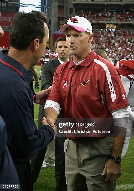 Head coach Ken Whisenhunt of the Arizona Cardinals shakes hands with Gary Kubiak of the Houston Texans following the NFL game at the Universtity of...