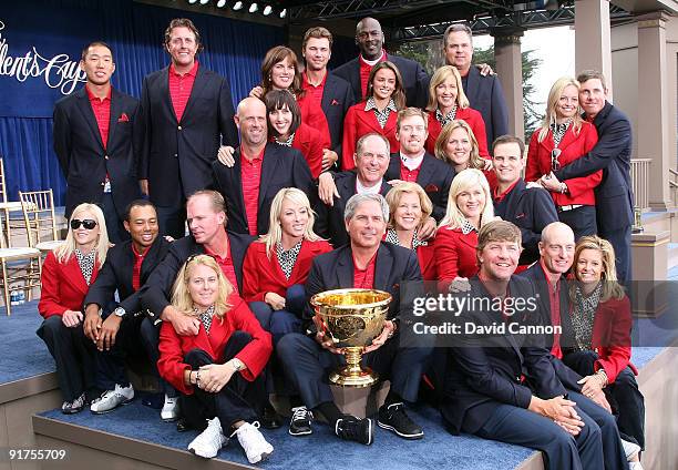 Members of the USA Team pose on stage with their wives and companions at the closing ceremonies after the USA defeated the International Team 19.5 to...