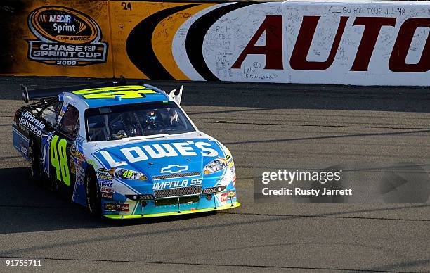 Jimmie Johnson, driver of the Lowe's Chevrolet, celebrates on the front stretch after winning the NASCAR Sprint Cup Series Pepsi 500 at Auto Club...