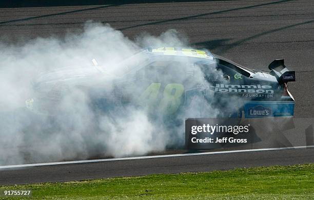 Jimmie Johnson, driver of the Lowe's Chevrolet, performs a burnout to celebrate winning the NASCAR Sprint Cup Series Pepsi 500 at Auto Club Speedway...