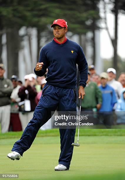 Tiger Woods of the U.S. Team reacts after sinking a birdie putt on during the final round singles matches for The Presidents Cup at Harding Park Golf...