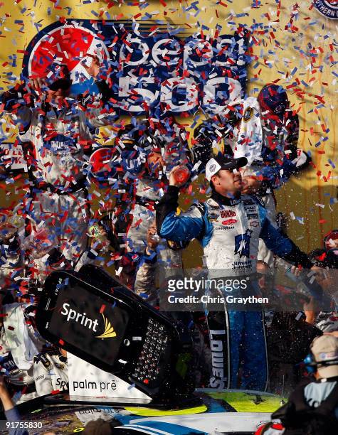 Jimmie Johnson, driver of the Lowe's Chevrolet, celebrates in victory lane after winning the NASCAR Sprint Cup Series Pepsi 500 at Auto Club Speedway...