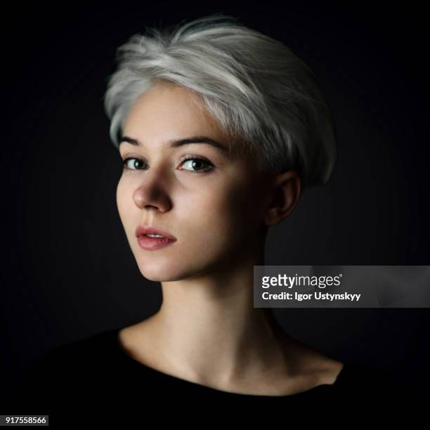 portrait of young woman on the black background - portrait white hair studio stock pictures, royalty-free photos & images