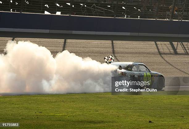 Jimmie Johnson, driver of the Lowe's Chevrolet, performs a burnout to celebrate winning the NASCAR Sprint Cup Series Pepsi 500 at Auto Club Speedway...