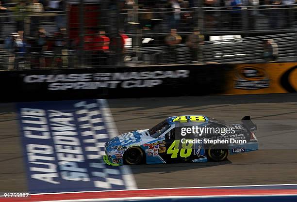 Jimmie Johnson, driver of the Lowe's/Jimmie Johnson Foundation Chevrolet, crosses the finsih line to win the NASCAR Sprint Cup Series Pepsi 500 at...