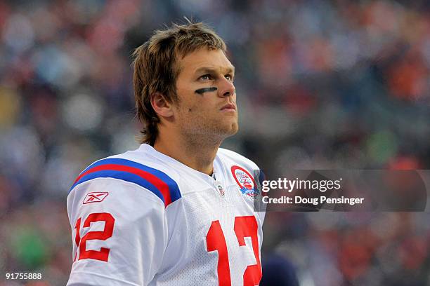 Quarterback Tom Brady of the New England Patriots looks on from the sidelines against the Denver Broncos during NFL action at Invesco Field at Mile...