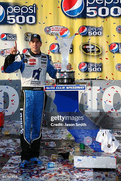 Jimmie Johnson, driver of the Lowe's Chevrolet, celebrates in victory lane after winning the NASCAR Sprint Cup Series Pepsi 500 at Auto Club Speedway...