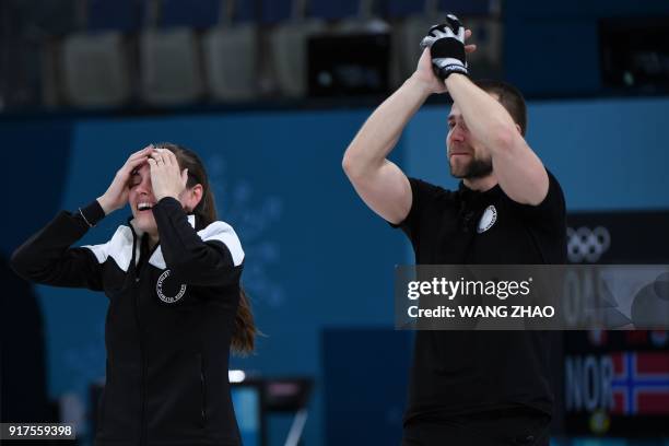 Russia's Anastasia Bryzgalova and Russia's Aleksandr Krushelnitckii celebrate after winning the curling mixed doubles bronze medal game during the...