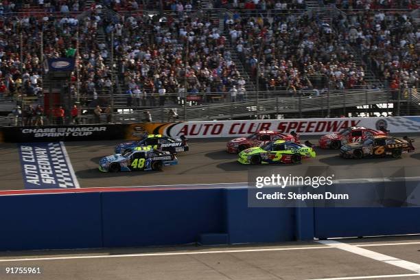 Jimmie Johnson, driver of the Lowe's/Jimmie Johnson Foundation Chevrolet, leads the field at the final restart of the NASCAR Sprint Cup Series Pepsi...