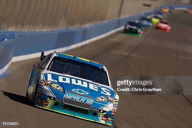 Jimmie Johnson, driver of the Lowe's Chevrolet, leads the field during the NASCAR Sprint Cup Series Pepsi 500 at Auto Club Speedway on October 11,...