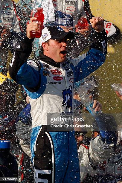 Jimmie Johnson, driver of the Lowe's Chevrolet, celebrates in victory lane after winning the NASCAR Sprint Cup Series Pepsi 500 at Auto Club Speedway...