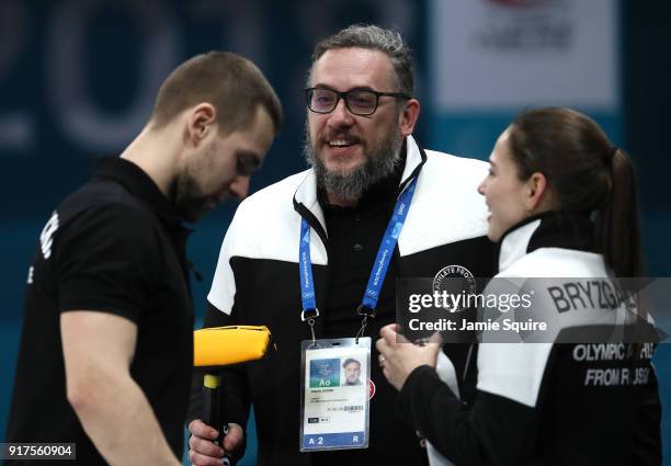 Anastasia Bryzgalova and Aleksandr Krushelnitckii of Olympic Athletes from Russia celebrate with coach Vasily Gudin after defeating Norway to win the...