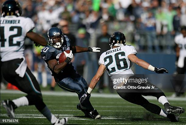 Running back Justin Forsett of the Seattle Seahawks rushes against Brian Russell of the Jacksonville Jaguars on October 11, 2009 at Qwest Field in...