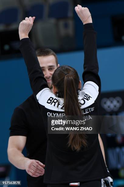 Russia's Anastasia Bryzgalova celebrates with Aleksandr Krushelnitckii after winning the curling mixed doubles bronze medal game during the...