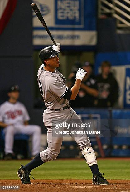 Alex Rodriguez of the New York Yankees follows the flight of his solo home run in the 7th inning against the Minnesota Twins in Game Three of the...