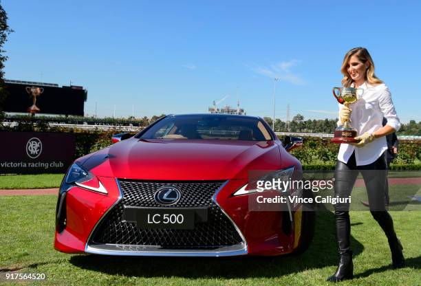 Kate Waterhouse is seen holding the 2018 Melbourne Cup after driving the Lexus LC 500 during the VRC Melbourne Cup Sponsorship Announcement at...