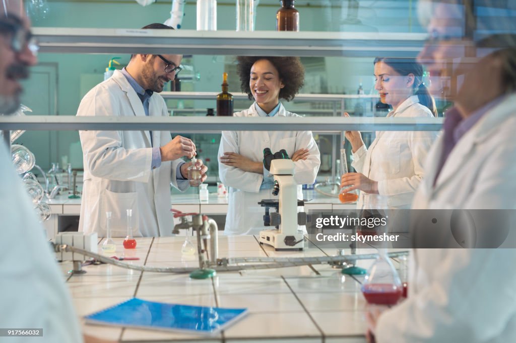 Team Of Happy Lab Workers Working On Forensic Experiment In Laboratory ...