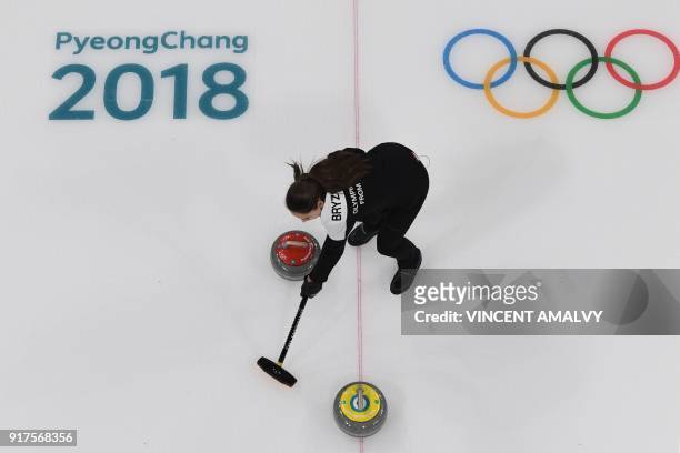 Russia's Anastasia Bryzgalova brushes the ice surface during the curling mixed doubles bronze medal game during the Pyeongchang 2018 Winter Olympic...