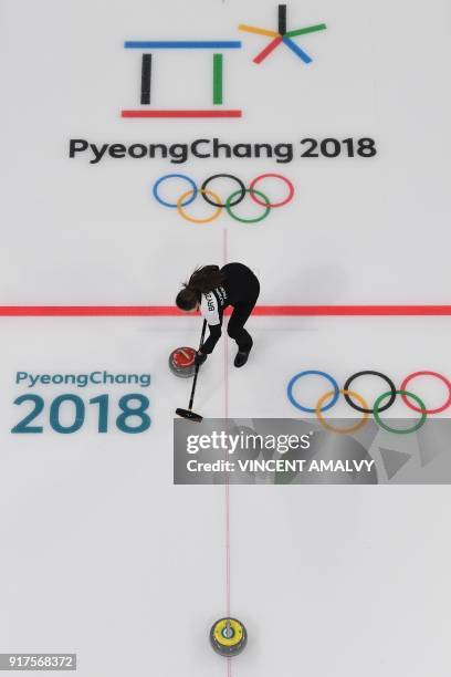 Russia's Anastasia Bryzgalova brushes the ice surface during the curling mixed doubles bronze medal game during the Pyeongchang 2018 Winter Olympic...