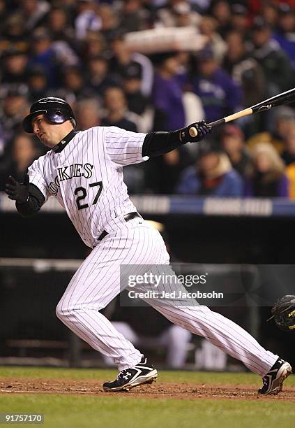 Garrett Atkins of the Colorado Rockies hits an rbi single against the Philadelphia Phillies in Game Three of the NLDS during the 2009 MLB Playoffs at...