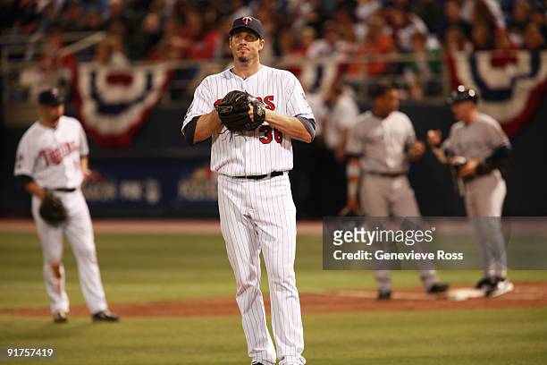 Pitcher Joe Nathan of the Minnesota Twins sighs after Alex Rodriguez of the New York Yankees scored in the ninth inning on a Robinson Cano of the...