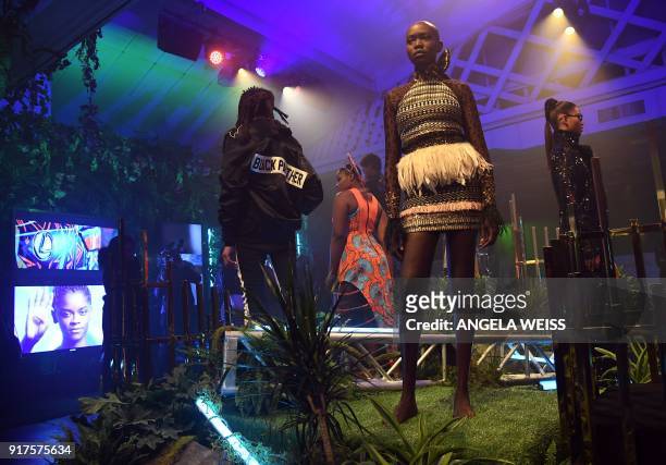 Models poses during the MARVEL Black Panther fashion week celebration "Welcome to Wakanda" at Industria on February 12 in New York. / AFP PHOTO /...