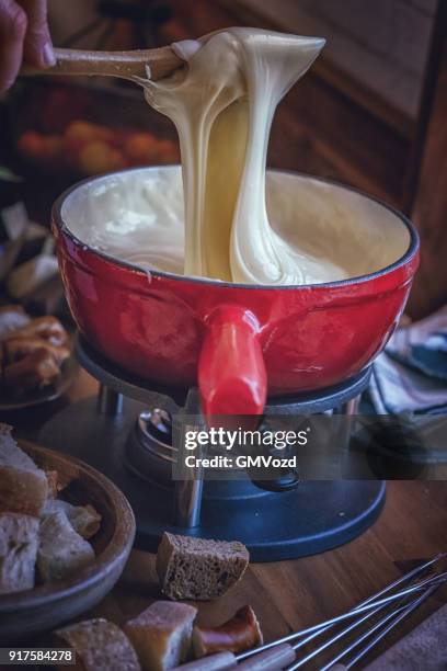 delicious swiss cheese fondue in a pot served with bread - cheese fondue stock pictures, royalty-free photos & images