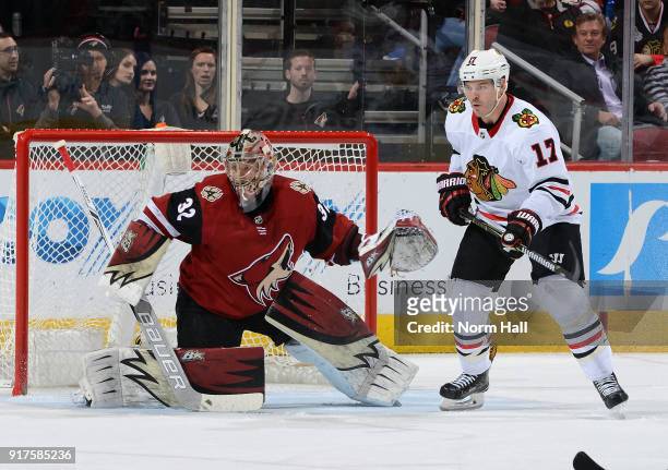 Lance Bouma of the Chicago Blackhawks looks for the puck as he positions himself in front of goalie Antti Raanta of the Arizona Coyotes during the...